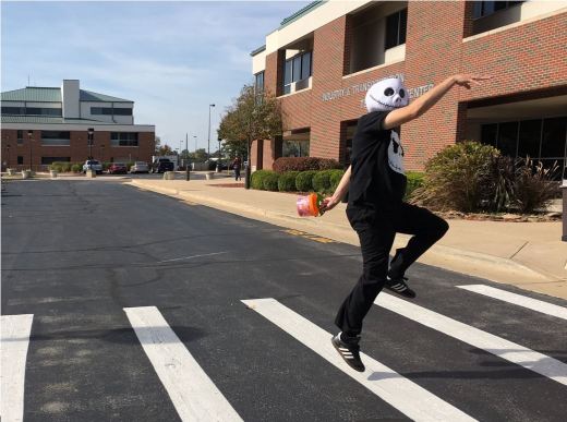 Darren Myers, Middle College counselor, dresses up as Jack Skellington skips across the crosswalk at ITTC building at OTC - Springfield. Pedestrian accidents are among the most common dangers children face each Halloween night. 